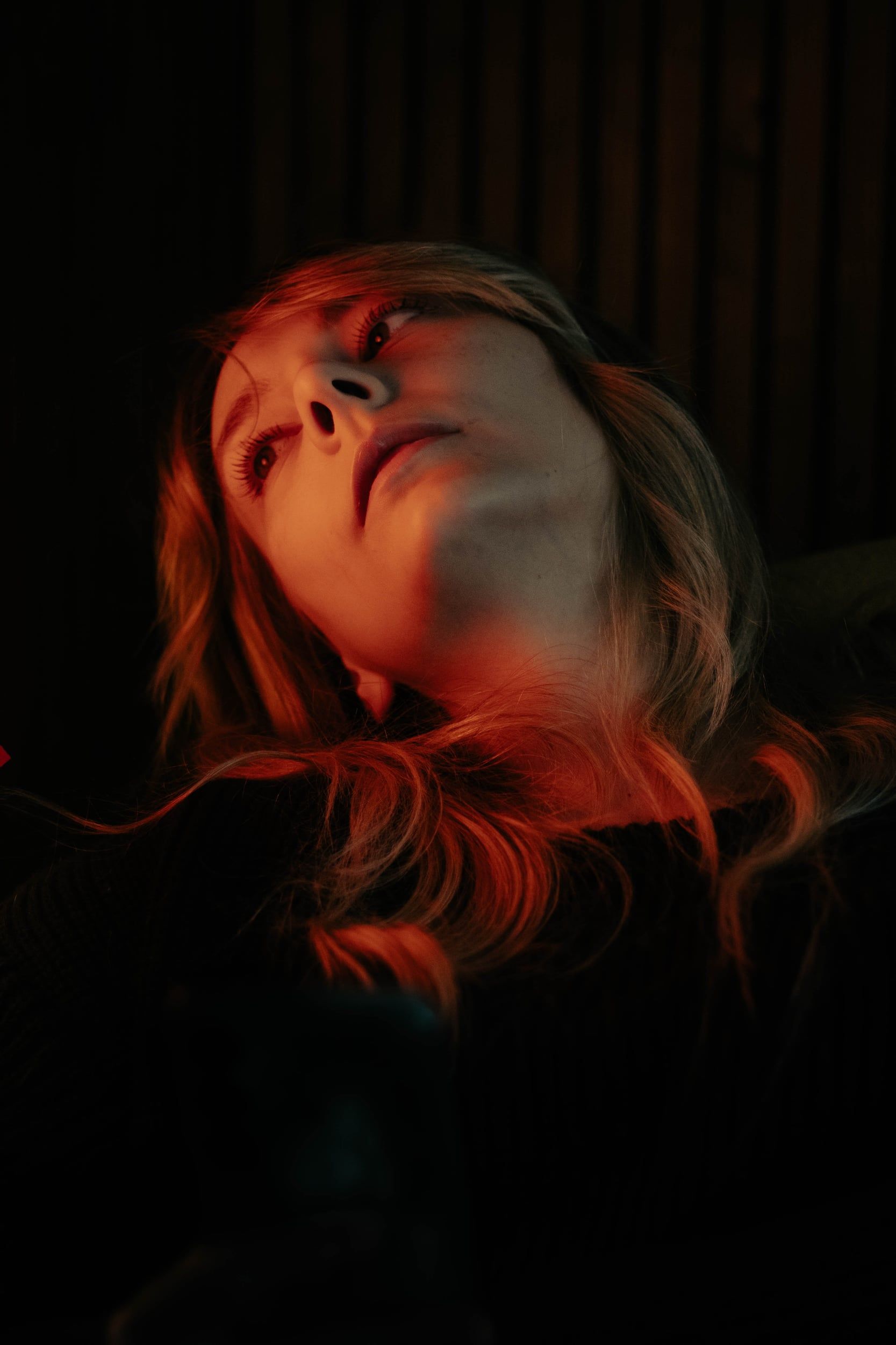 Low-key portrait lit in red